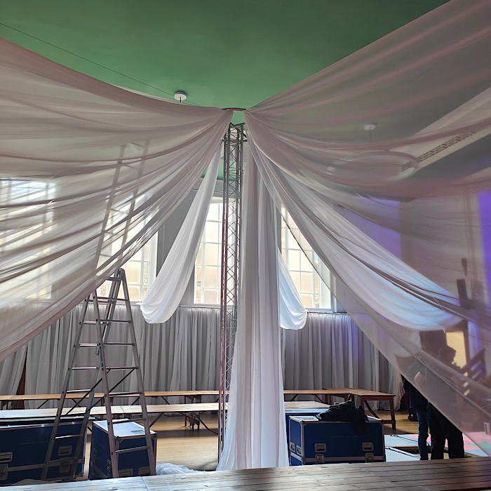 White ceiling drapes with central scaffolding tower {{brizy_dc_image_alt imageSrc=
