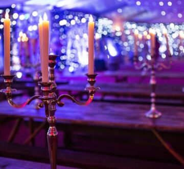 Candelabras and starcloth and venue lighting at a corporate event