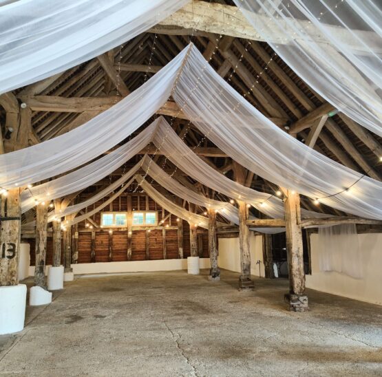 White ceiling wedding drapes in a barn