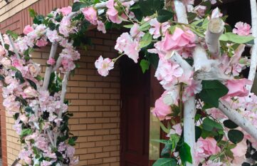 Woodland weddings archway. in pink and peach flowers.